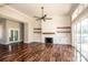 Bright living room with hardwood floors, fireplace, ceiling fan, and sliding doors to the patio at 6098 Ballard Rd, Denver, NC 28037