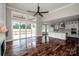 Spacious living area with hardwood floors, fireplace, and an open layout to the kitchen and outdoor deck at 6098 Ballard Rd, Denver, NC 28037