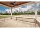 View from a porch with wood railing and ceiling fan overlooking natural backyard at 6098 Ballard Rd, Denver, NC 28037