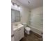 Bright bathroom featuring a white vanity, modern lighting, and a clean, white tub and shower combination at 6140 Whispering Brook Ct, Charlotte, NC 28216