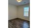 Serene bedroom with natural light, window, and wood-look flooring, providing a tranquil atmosphere at 6140 Whispering Brook Ct, Charlotte, NC 28216