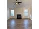 Bright living room featuring a modern ceiling fan and fireplace at 6140 Whispering Brook Ct, Charlotte, NC 28216