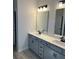 Bathroom with a double sink vanity, modern light fixtures, and two large mirrors at 6332 Honor Ave, Midland, NC 28107