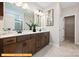 Double vanity bathroom with brown cabinets and a walk-in shower at 6332 Honor Ave, Midland, NC 28107