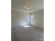 Empty carpeted bedroom with neutral walls, recessed lighting, and a sunny window at 6332 Honor Ave, Midland, NC 28107