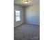 Cozy bedroom featuring a large window and a neutral-toned carpet at 6332 Honor Ave, Midland, NC 28107