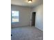 Clean and bright bedroom with carpet, a window, and an open door at 6332 Honor Ave, Midland, NC 28107