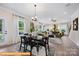 Open concept dining area with black chairs and a view into the living room at 6332 Honor Ave, Midland, NC 28107