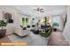 Spacious living room with white couch, green accent chairs, and large windows at 6332 Honor Ave, Midland, NC 28107