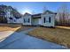 Charming one-story home with green siding, black shutters, and a well-manicured front yard at 709 Queens Ct, Gastonia, NC 28052