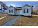 Charming one-story home with green siding, black shutters, and a well-manicured front yard at 709 Queens Ct, Gastonia, NC 28052