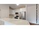 Modern kitchen featuring white cabinets, stainless steel appliances, and a marble countertop at 709 Queens Ct, Gastonia, NC 28052