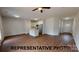 Open-concept living room featuring hardwood floors, a modern kitchen, and ample natural light at 709 Queens Ct, Gastonia, NC 28052