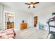 Bedroom with carpet, white trim, ceiling fan, dresser, and a bed with a colorful quilt at 7191 Three Kings Rd, Fort Mill, SC 29715