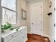 Bright entryway with storage cabinet, coat hooks, and dark wood floors at 7191 Three Kings Rd, Fort Mill, SC 29715