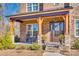 Inviting front porch with decorative columns, rocking chairs, and a wreath on the front door at 7191 Three Kings Rd, Fort Mill, SC 29715