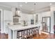 Modern kitchen with white cabinets, a large island, stainless steel appliances, and hardwood floors at 7191 Three Kings Rd, Fort Mill, SC 29715