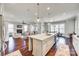 Open concept kitchen with a center island that views into other living spaces at 7191 Three Kings Rd, Fort Mill, SC 29715