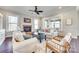 Spacious living room boasts a cozy fireplace, ceiling fan, and plenty of natural light at 7191 Three Kings Rd, Fort Mill, SC 29715