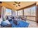 Cozy screened-in porch with blue patterned rug, ceiling fan, and outdoor seating at 7191 Three Kings Rd, Fort Mill, SC 29715