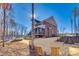 Exterior rear view shows brick facade, screened porch, and outdoor firepit seating area at 7191 Three Kings Rd, Fort Mill, SC 29715