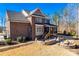 Exterior view showcases brick, spacious backyard with a fire pit and screened porch at 7191 Three Kings Rd, Fort Mill, SC 29715