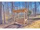 Wooden swing set in a backyard setting, ideal for Gathering enjoyment and recreation at 7191 Three Kings Rd, Fort Mill, SC 29715