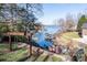 Scenic backyard with a swing set and views of the lake and boat docks. It’s outdoor enjoyment at its best! at 7535 Rabbit Cir, Denver, NC 28037