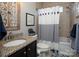 Cozy bathroom featuring a vanity sink, a bathtub with a shower curtain, and tasteful decor elements at 7535 Rabbit Cir, Denver, NC 28037