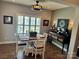 Bright dining area with table and chairs, hardwood floors, and plantation shutters at 7535 Rabbit Cir, Denver, NC 28037