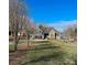 Gray house with stone accents, double garage, and a large front yard at 7535 Rabbit Cir, Denver, NC 28037