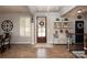 Inviting foyer with hardwood floors, a decorative bench, and plenty of natural light at 7535 Rabbit Cir, Denver, NC 28037