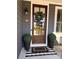 Charming front entry with a wood door, wreath, and potted plants at 7535 Rabbit Cir, Denver, NC 28037