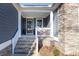 Charming front porch with stone stairs and pillars, with an inviting entryway at 7535 Rabbit Cir, Denver, NC 28037