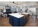 Kitchen island with seating and a copper sink, flowing into a living room and dining area for easy entertaining at 7535 Rabbit Cir, Denver, NC 28037