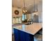 Large kitchen island with white quartz countertops and blue cabinetry at 7535 Rabbit Cir, Denver, NC 28037