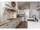 Close-up of a kitchen with a gas range, granite countertops, stainless steel refrigerator, and custom white cabinetry at 7535 Rabbit Cir, Denver, NC 28037