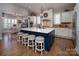 Spacious kitchen featuring a large island with seating, stainless steel appliances, and modern lighting fixtures at 7535 Rabbit Cir, Denver, NC 28037