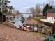 Kayaks on the lakefront with a pergola and steps down to the water at 7535 Rabbit Cir, Denver, NC 28037