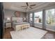 Serene main bedroom with tray ceiling, ample natural light, and a cozy bench at the foot of the bed at 7535 Rabbit Cir, Denver, NC 28037