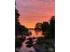 Stunning sunset over calm lake waters with boats and docks visible at 7535 Rabbit Cir, Denver, NC 28037