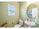 Small powder room with single sink vanity and decorative mirror at 821 Bethesda Rd, Statesville, NC 28677