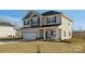 Two-story house with gray and beige siding, a front porch, and a well-maintained lawn at 821 Bethesda Rd, Statesville, NC 28677