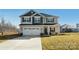 Two-story house with gray and beige siding, a large driveway, and a grassy yard at 821 Bethesda Rd, Statesville, NC 28677