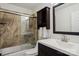 Bathroom with vanity, shower/tub combo, and dark brown cabinet at 8720 Tamarron Dr, Charlotte, NC 28277