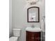 Small bathroom with a pedestal sink, toilet and mirror at 8720 Tamarron Dr, Charlotte, NC 28277