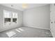 Well-lit bedroom with gray carpeting and a large window at 8720 Tamarron Dr, Charlotte, NC 28277