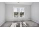 Bright bedroom with gray carpet and a large window, offering natural light at 8720 Tamarron Dr, Charlotte, NC 28277