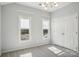 Well-lit bedroom with two windows and double doors at 8720 Tamarron Dr, Charlotte, NC 28277