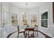 Breakfast nook with glass table and chairs, overlooking backyard at 8720 Tamarron Dr, Charlotte, NC 28277